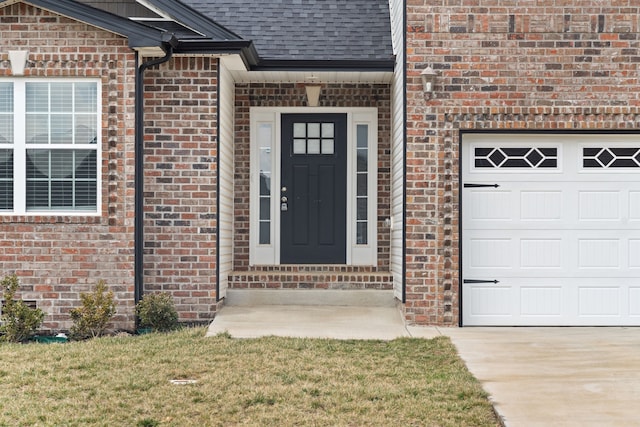 entrance to property with a yard and a garage