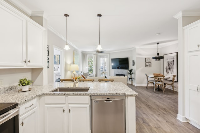 kitchen with kitchen peninsula, white cabinetry, light wood-type flooring, dishwasher, and sink