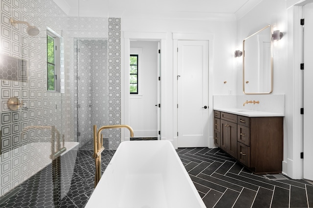 bathroom featuring vanity, crown molding, tile walls, and a wealth of natural light