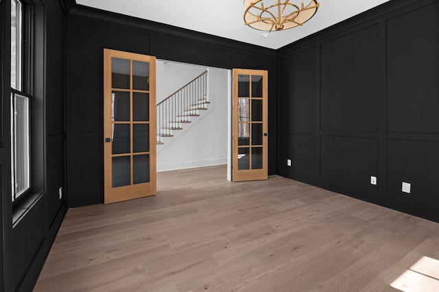 5104 Cobbler Ridge Ct, Franklin, TN 37064 - spare room featuring a notable chandelier, stairway, french doors, a decorative wall, and light wood finished floors