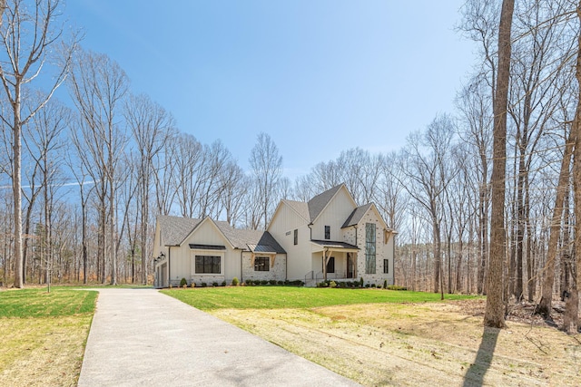 5104 Cobbler Ridge Ct, Franklin, TN 37064 - view of front of home with driveway, board and batten siding, stone siding, a front yard, and a shingled roof