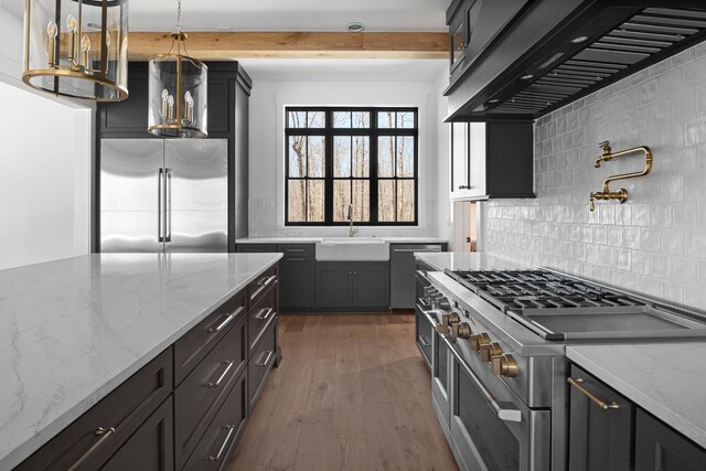 5104 Cobbler Ridge Ct, Franklin, TN 37064 - kitchen featuring tasteful backsplash, high end appliances, extractor fan, a sink, and wood finished floors