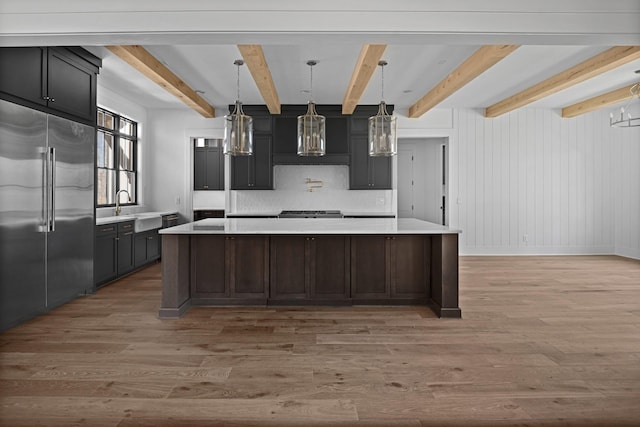 5104 Cobbler Ridge Ct, Franklin, TN 37064 - kitchen featuring built in refrigerator, light countertops, beamed ceiling, light wood finished floors, and a spacious island