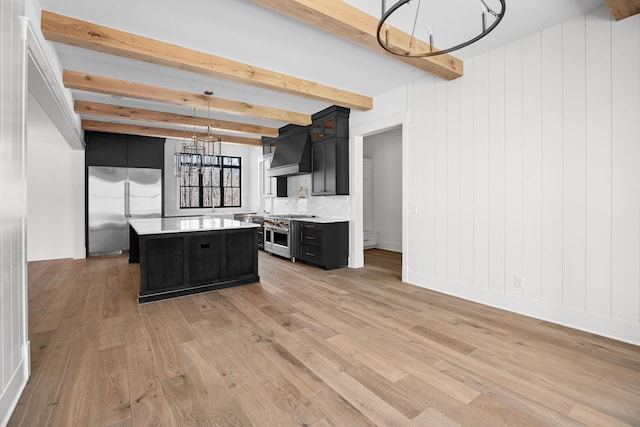 5104 Cobbler Ridge Ct, Franklin, TN 37064 - kitchen with custom exhaust hood, light countertops, dark cabinetry, premium appliances, and a notable chandelier