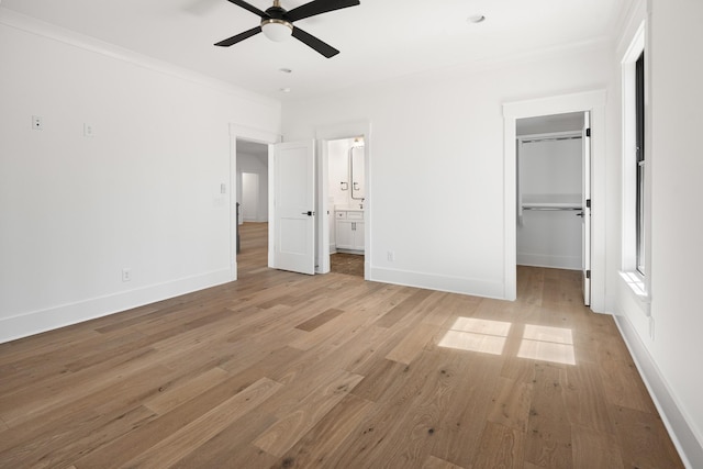 5104 Cobbler Ridge Ct, Franklin, TN 37064 - unfurnished bedroom featuring a spacious closet, baseboards, light wood-type flooring, and crown molding