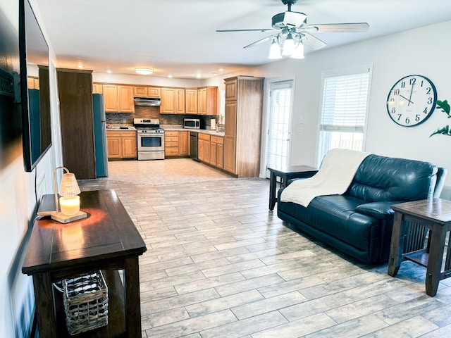 interior space with sink, light hardwood / wood-style floors, and ceiling fan