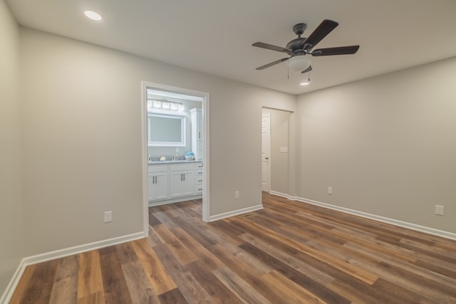 unfurnished bedroom with ensuite bathroom, ceiling fan, and dark hardwood / wood-style floors