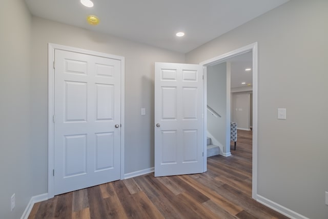 unfurnished bedroom with dark wood-type flooring