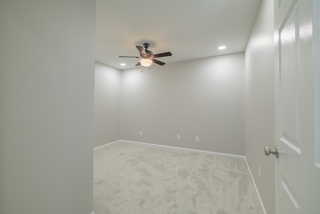 empty room with ceiling fan and light carpet