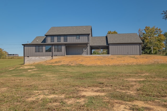 rear view of property with a lawn