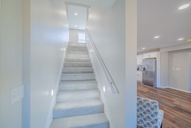 stairs with wood-type flooring