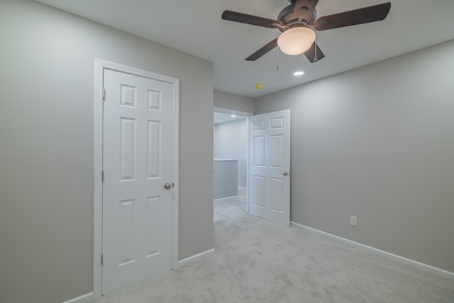 unfurnished bedroom with ceiling fan and light carpet