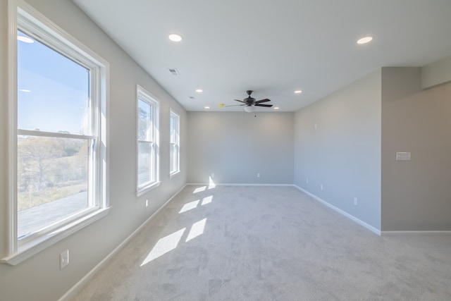 carpeted spare room featuring ceiling fan