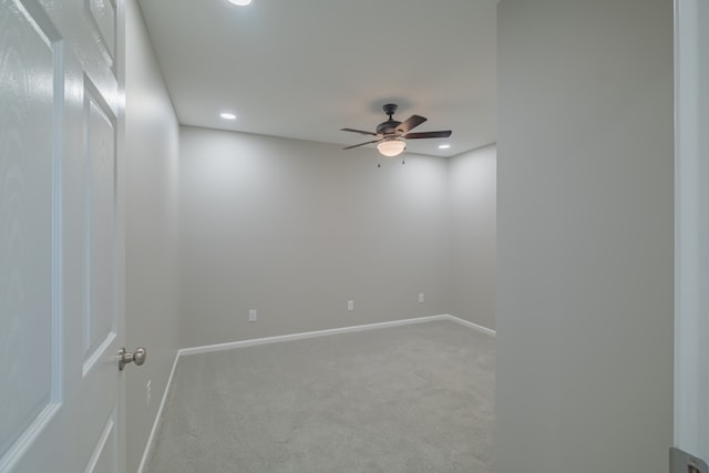 unfurnished room featuring ceiling fan and carpet