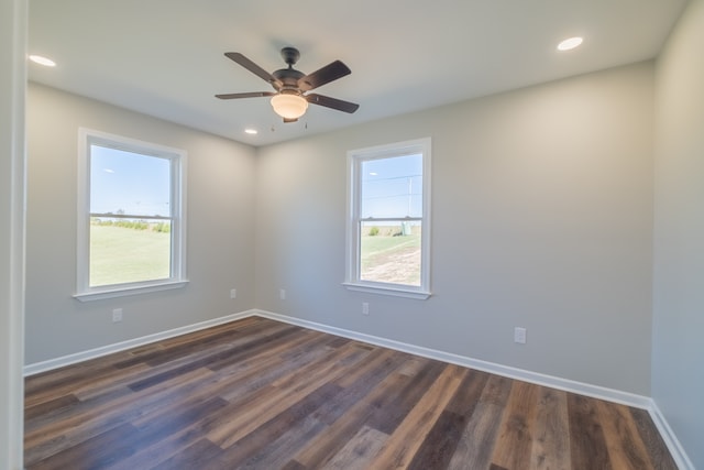 unfurnished room featuring dark hardwood / wood-style flooring, ceiling fan, and a healthy amount of sunlight