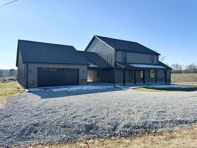 view of front of property with covered porch and a garage