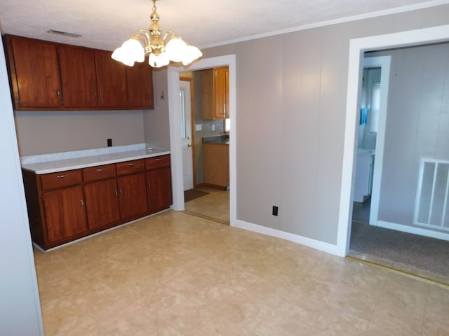 kitchen featuring ornamental molding, a chandelier, and decorative light fixtures