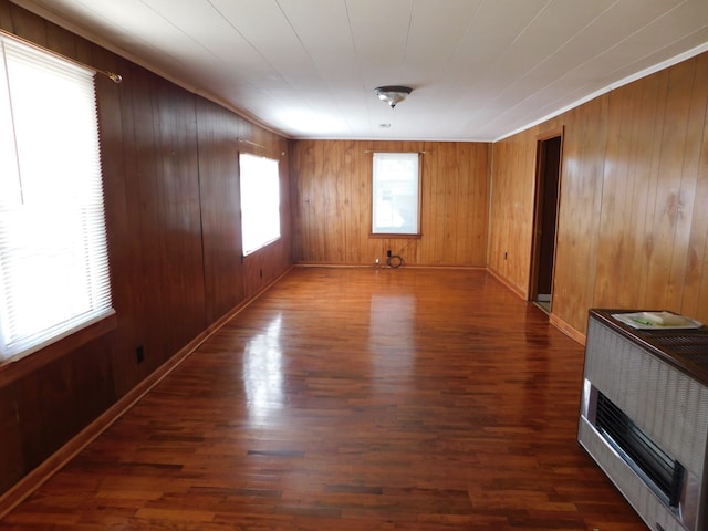 spare room featuring wooden walls and dark hardwood / wood-style floors