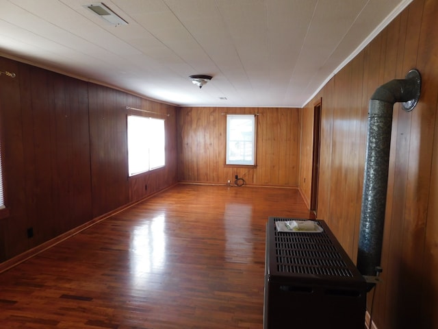 empty room featuring hardwood / wood-style floors and wood walls