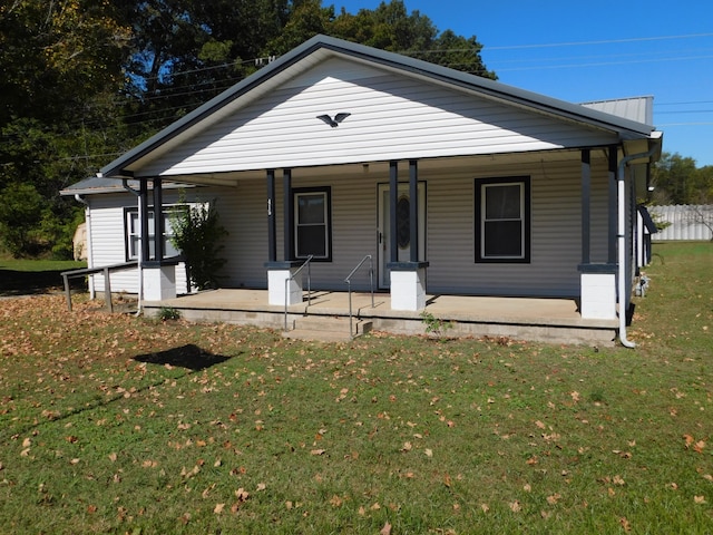 view of front of house with a front yard and a porch