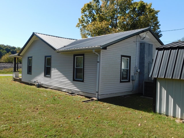 view of home's exterior with a yard and a shed