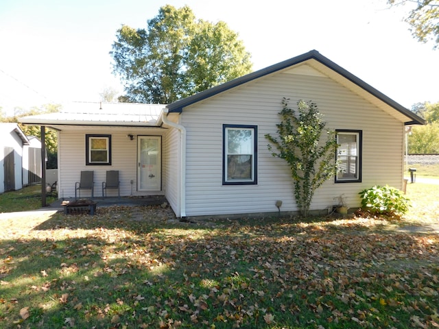 rear view of property featuring a yard and a patio