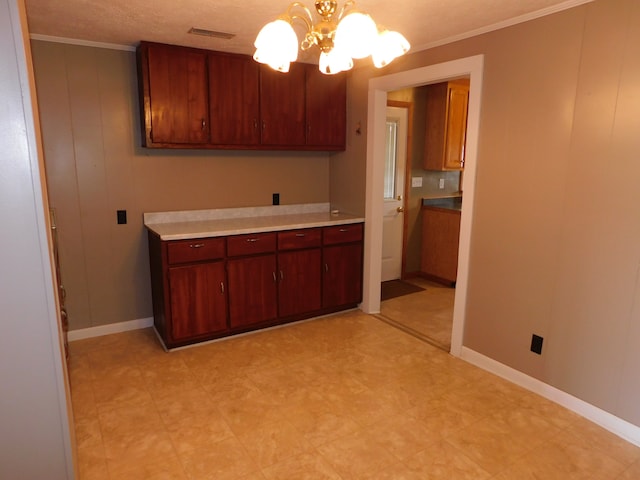 kitchen with ornamental molding, decorative light fixtures, and an inviting chandelier