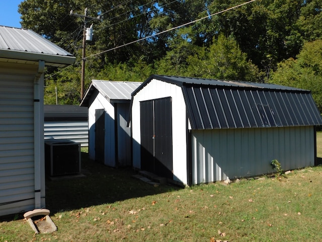 view of outdoor structure featuring a lawn