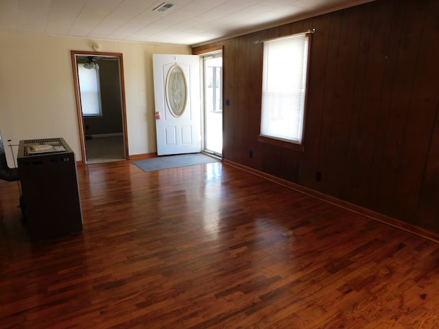 entrance foyer with wood walls and dark hardwood / wood-style flooring