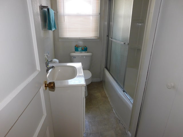 full bathroom with vanity, toilet, and combined bath / shower with glass door