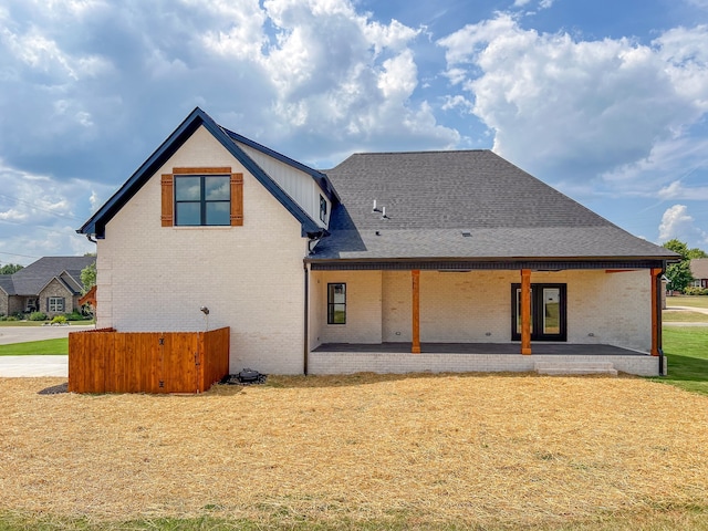 rear view of property featuring a lawn