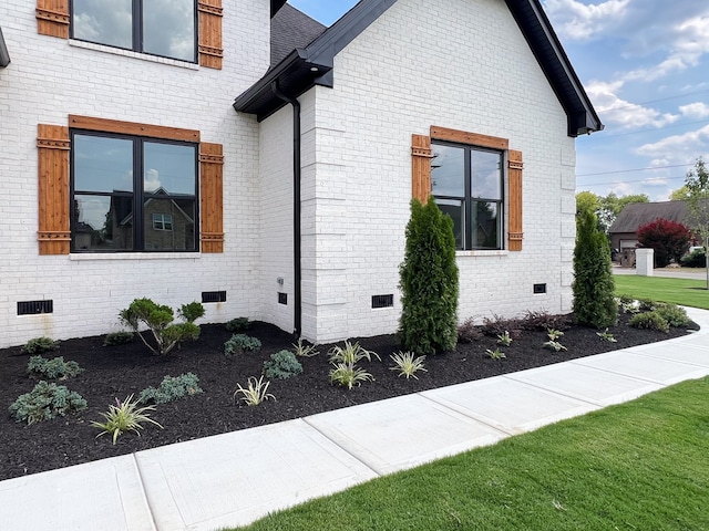 view of side of home with a yard