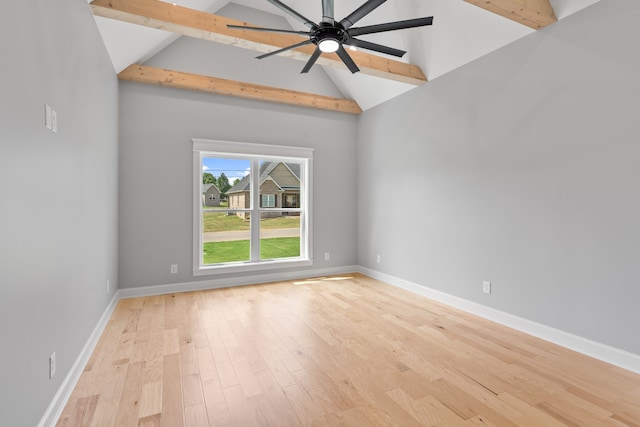 empty room featuring beam ceiling, high vaulted ceiling, light wood-type flooring, and ceiling fan