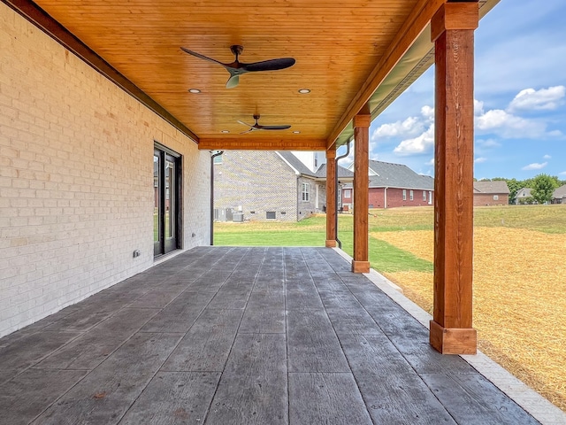 wooden deck with a patio, a yard, and ceiling fan