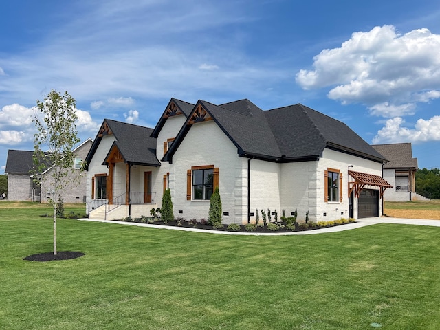 view of front of home with a front yard and a garage