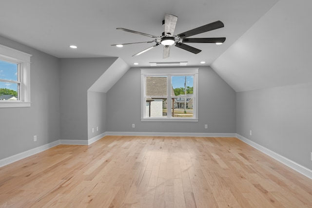 bonus room featuring vaulted ceiling, ceiling fan, light wood-type flooring, and a wealth of natural light