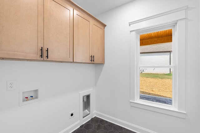 clothes washing area featuring dark tile patterned floors, hookup for an electric dryer, washer hookup, and cabinets