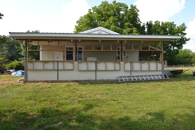 rear view of house with a yard