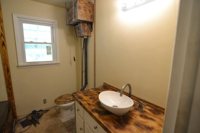 bathroom featuring toilet, vanity, and tile patterned floors