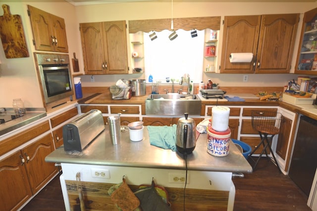 kitchen with dark hardwood / wood-style flooring, sink, and stainless steel oven