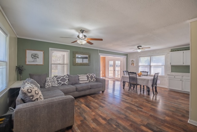 living room with french doors, a textured ceiling, ceiling fan, dark wood-type flooring, and ornamental molding