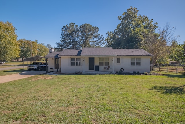 ranch-style home with a front yard and a carport