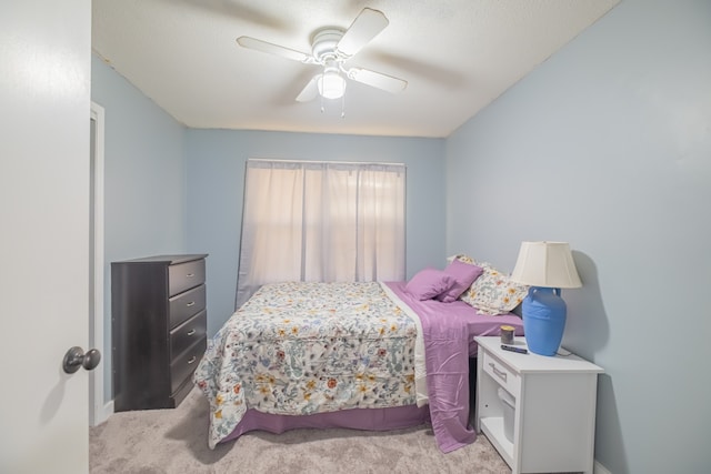 bedroom featuring light colored carpet and ceiling fan