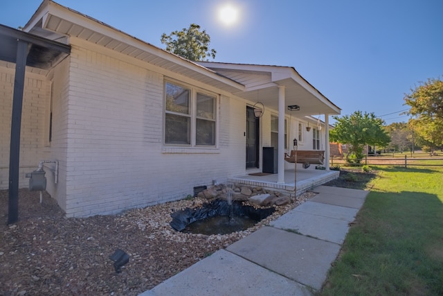 view of side of home featuring a yard