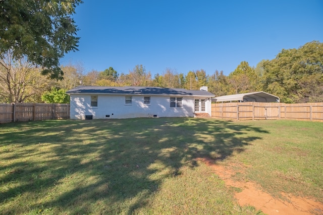 back of house with a yard