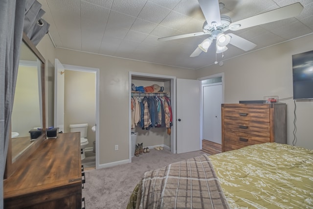 bedroom featuring a closet, ceiling fan, carpet floors, and ensuite bath