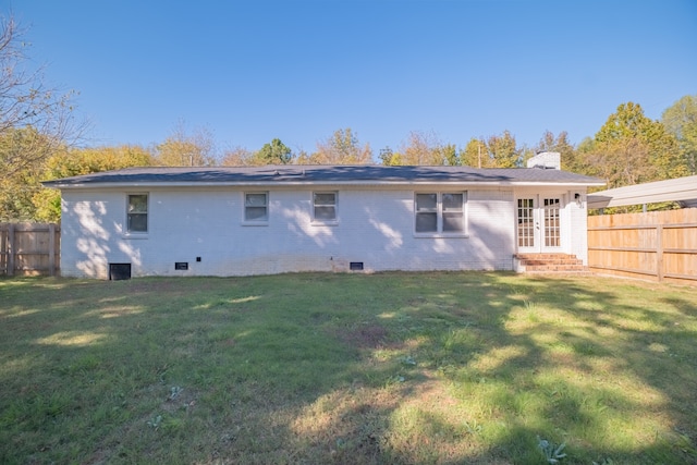 rear view of house with a yard