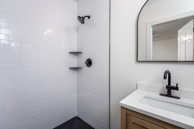 bathroom with vanity and tiled shower