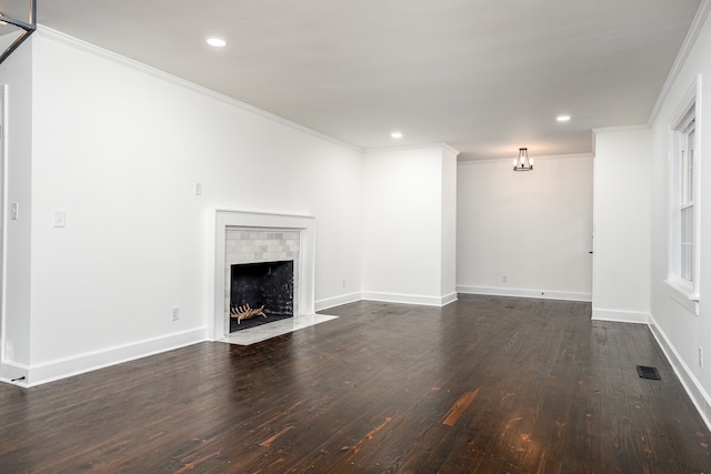 unfurnished living room featuring dark wood-type flooring and crown molding