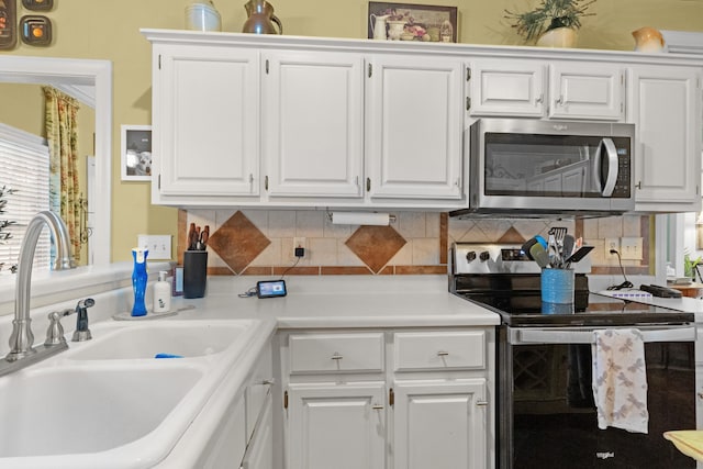 kitchen featuring sink, white cabinets, and stainless steel appliances